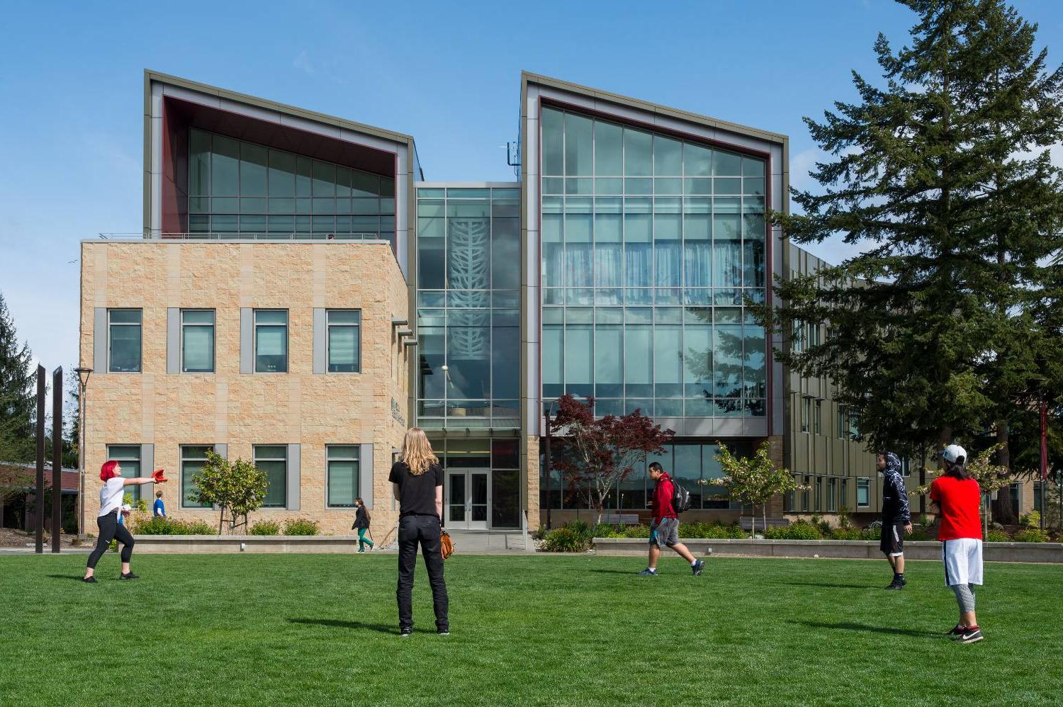 TCC students playing catch on a sunny day in the campus commons